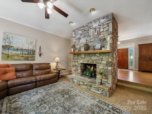 2988 Parks Lafferty Rd, Concord, NC 28025 - living room featuring ceiling fan, ornamental molding, a textured ceiling, baseboards, and a stone fireplace