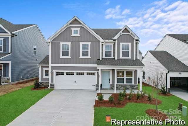 view of front of property featuring a garage, a front yard, and covered porch