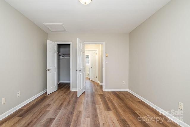 unfurnished bedroom featuring a closet and dark wood-type flooring