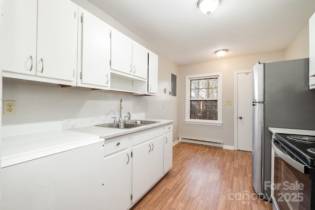 kitchen with electric range, light hardwood / wood-style flooring, sink, a baseboard radiator, and white cabinets