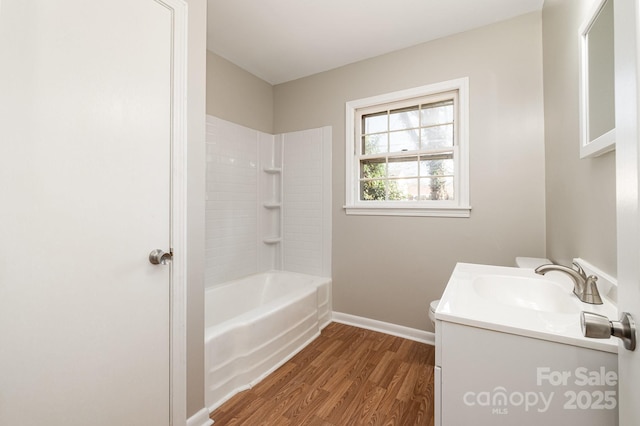 bathroom with hardwood / wood-style flooring, shower / tub combination, and vanity