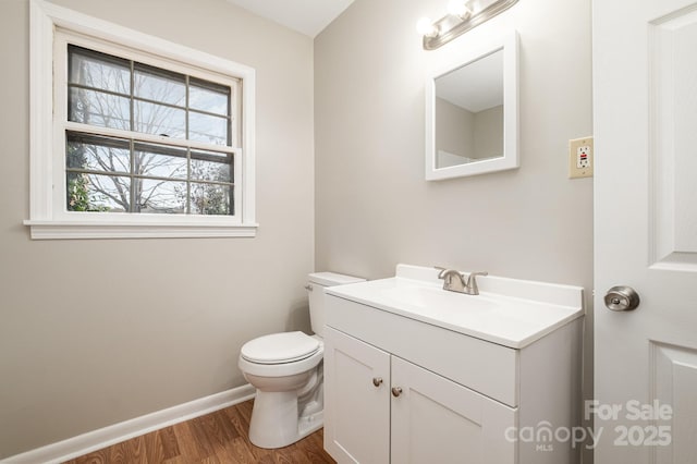 bathroom featuring vanity, toilet, and hardwood / wood-style floors