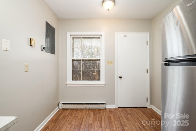 entryway with hardwood / wood-style flooring and a baseboard heating unit