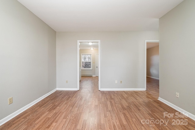 spare room featuring light hardwood / wood-style flooring