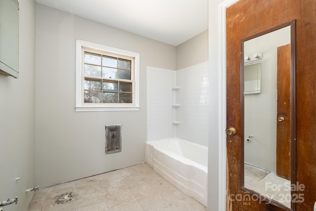 bathroom featuring heating unit, washtub / shower combination, and tile patterned floors