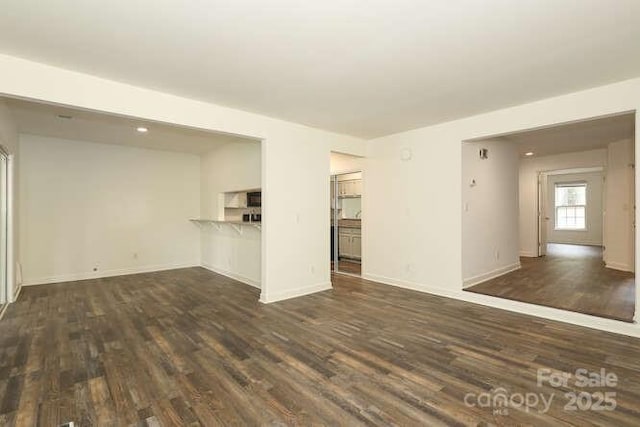 unfurnished living room featuring dark wood-type flooring