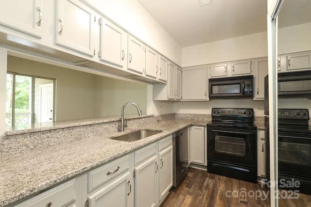 kitchen featuring white cabinetry, sink, black appliances, light stone countertops, and dark wood-type flooring