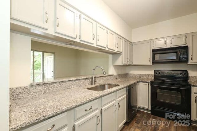 kitchen featuring sink, dark wood-type flooring, white cabinetry, light stone counters, and black appliances