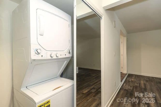 washroom featuring stacked washing maching and dryer and dark hardwood / wood-style floors