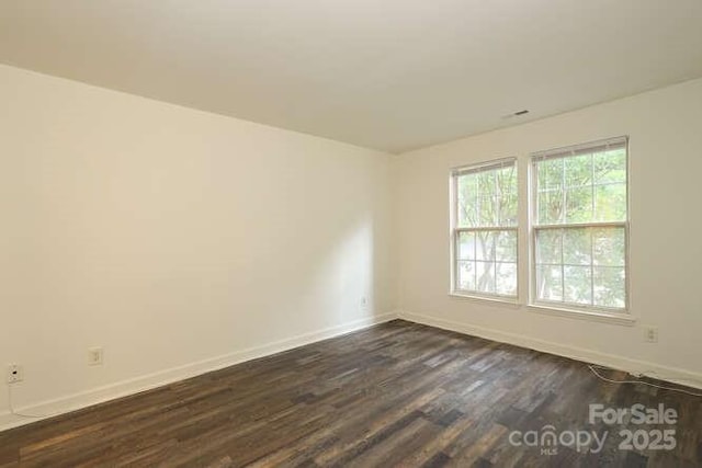 empty room with dark wood-type flooring