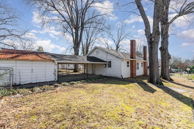 back of house with a lawn and a patio area