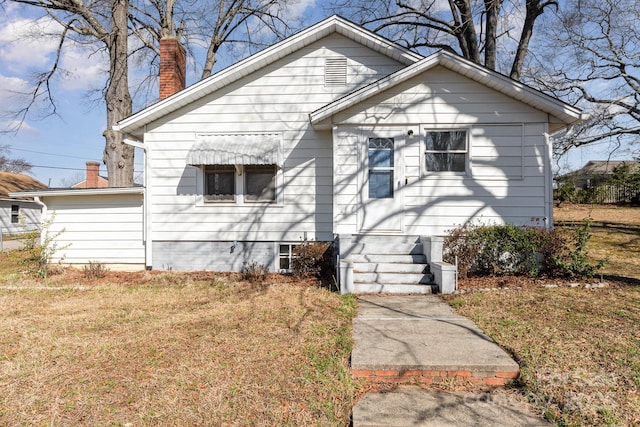 bungalow-style home with a front lawn