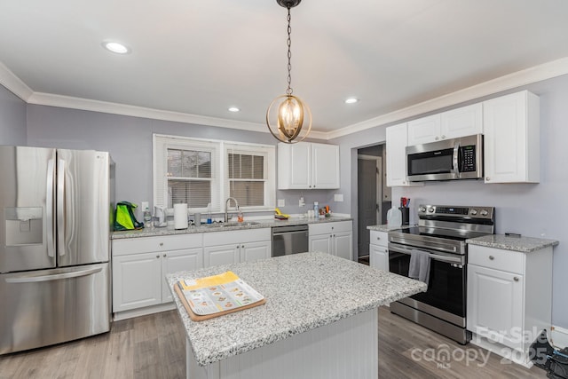 kitchen with a kitchen island, sink, stainless steel appliances, and white cabinets