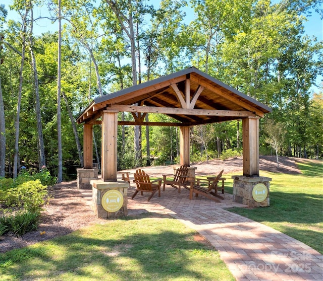 surrounding community with a gazebo and a yard