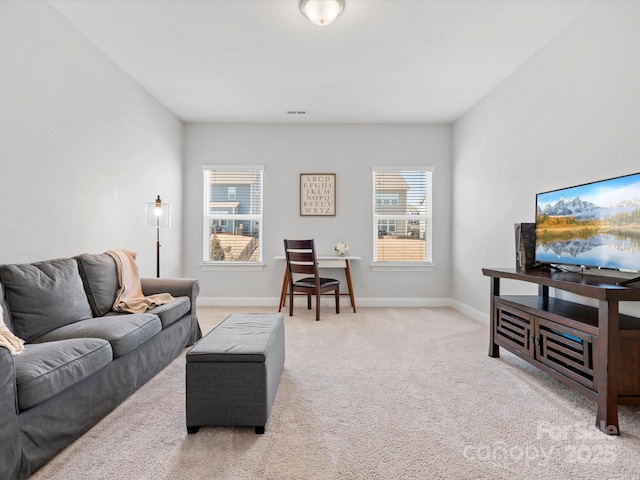 carpeted living area with visible vents and baseboards