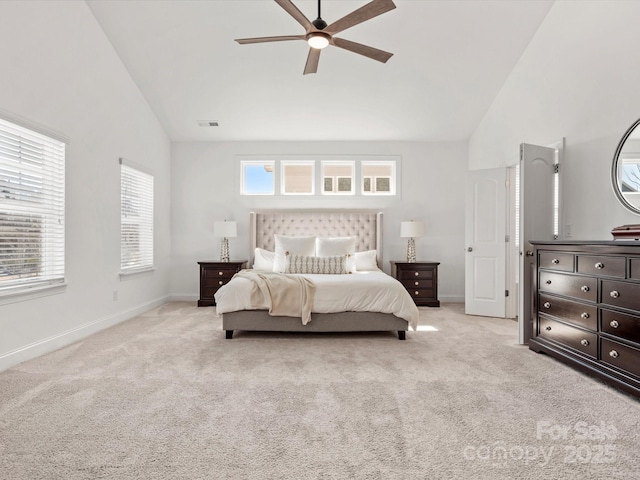 bedroom featuring visible vents, light colored carpet, and multiple windows