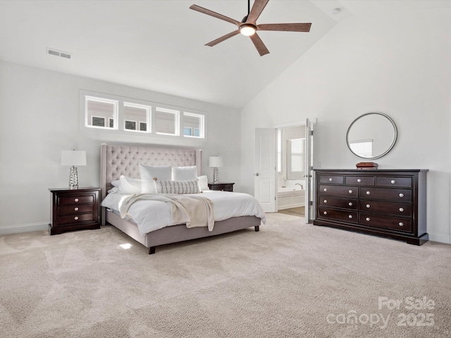 bedroom with baseboards, ensuite bathroom, carpet, and high vaulted ceiling