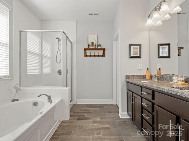 full bath with a bath, visible vents, a stall shower, and vanity