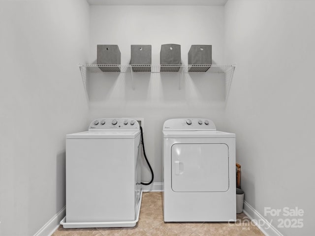 washroom featuring laundry area, washer and dryer, and baseboards