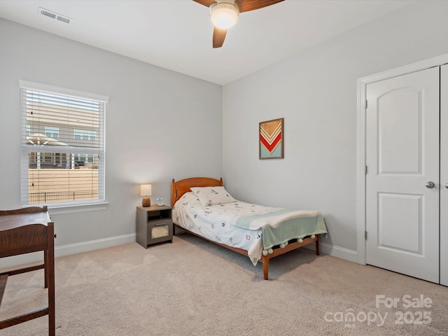 bedroom featuring ceiling fan, carpet, visible vents, and baseboards