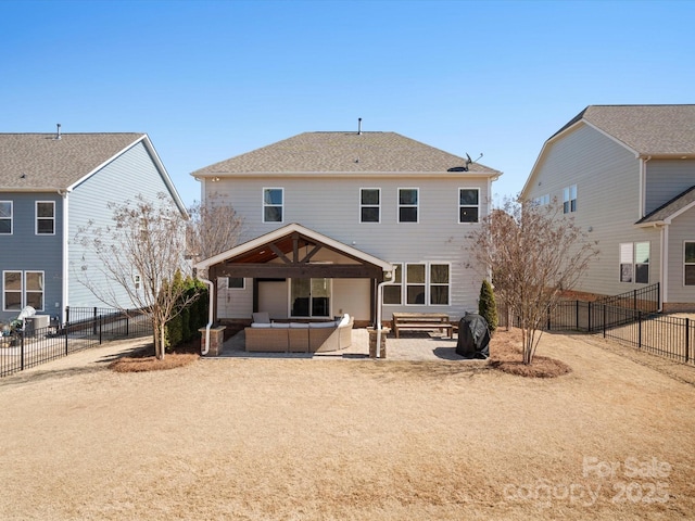 rear view of house with a patio, a fenced backyard, a hot tub, and an outdoor hangout area