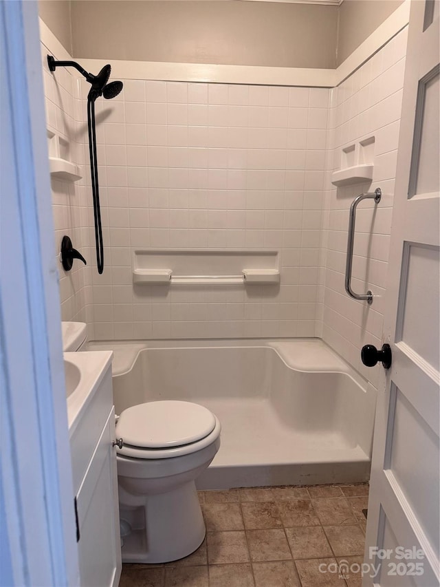 bathroom with vanity, toilet, and tiled shower