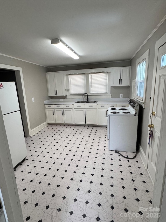 kitchen featuring sink, white appliances, and white cabinets