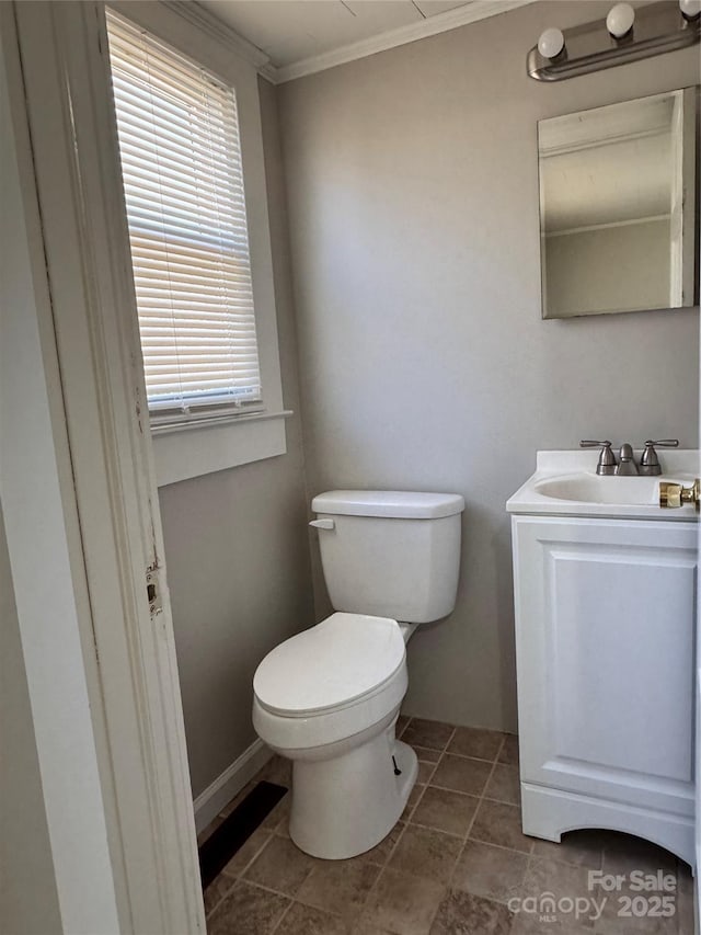 bathroom featuring vanity, tile patterned floors, crown molding, and toilet