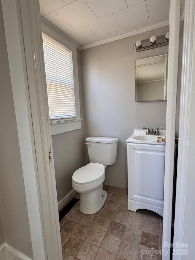 bathroom with crown molding, vanity, and toilet