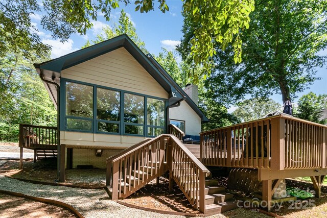 353 Whippoorwill Rd, Mooresville, NC 28117 - back of property with a wooden deck, stairway, and a sunroom