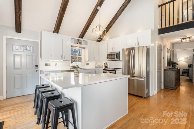 353 Whippoorwill Rd, Mooresville, NC 28117 - kitchen with appliances with stainless steel finishes, backsplash, high vaulted ceiling, light countertops, and a kitchen bar