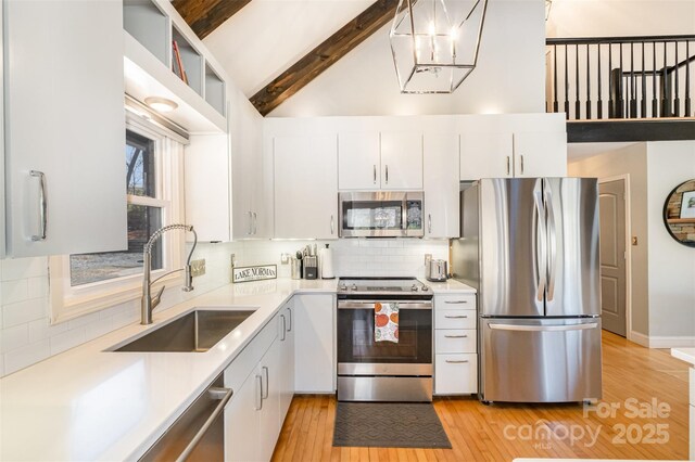 353 Whippoorwill Rd, Mooresville, NC 28117 - kitchen featuring stainless steel appliances, a sink, light wood-style flooring, light countertops, and white cabinets