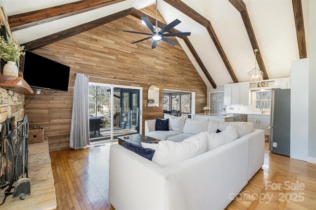 353 Whippoorwill Rd, Mooresville, NC 28117 - living room featuring high vaulted ceiling, wooden walls, ceiling fan, beam ceiling, and a fireplace