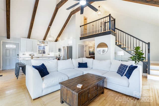 353 Whippoorwill Rd, Mooresville, NC 28117 - living area with high vaulted ceiling, ceiling fan, stairway, beam ceiling, and light wood-style floors