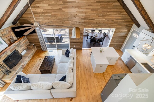 353 Whippoorwill Rd, Mooresville, NC 28117 - living area with wood walls, beamed ceiling, high vaulted ceiling, and wood finished floors