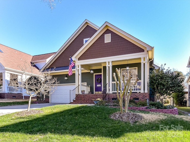 craftsman house with concrete driveway, a porch, a front lawn, and crawl space