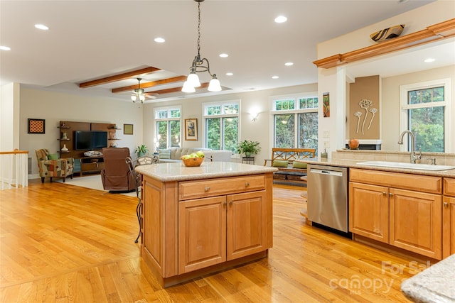 kitchen featuring decorative light fixtures, light wood-style flooring, open floor plan, a sink, and dishwasher