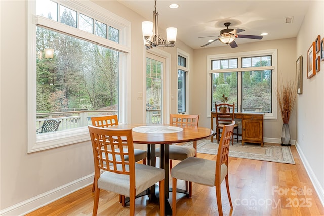 dining space with plenty of natural light, wood finished floors, and baseboards