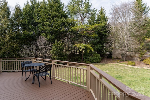 wooden terrace featuring a yard