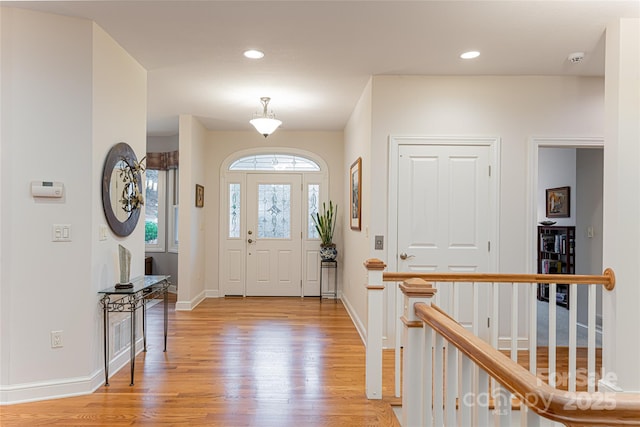 entrance foyer with light wood-style flooring, baseboards, and recessed lighting