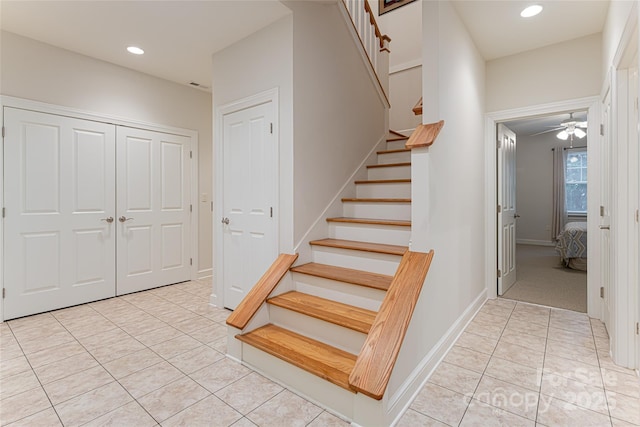 stairs featuring tile patterned flooring, baseboards, and recessed lighting