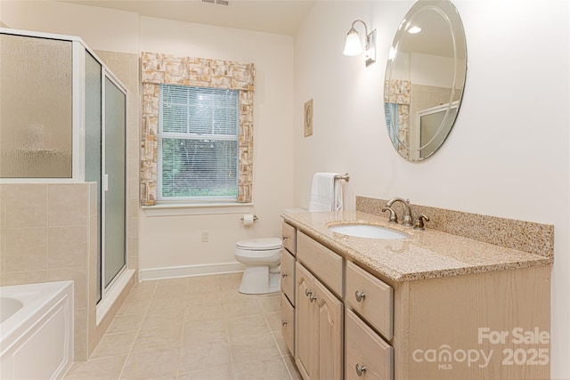 full bath with visible vents, toilet, a stall shower, vanity, and baseboards