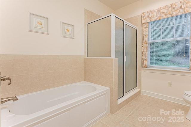 bathroom featuring a garden tub, a shower stall, toilet, and tile patterned floors