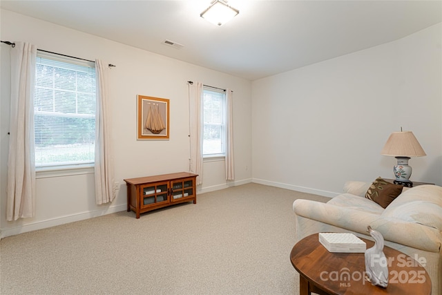 sitting room featuring a healthy amount of sunlight, carpet flooring, and visible vents