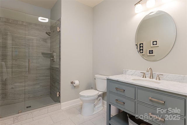 bathroom with toilet, a shower stall, baseboards, and vanity