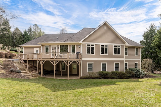 rear view of house featuring stairway, a lawn, and a wooden deck