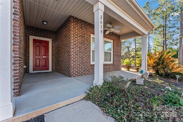 2439 Bergamot St, Fort Mill, SC 29708 - property entrance featuring a ceiling fan, covered porch, and brick siding