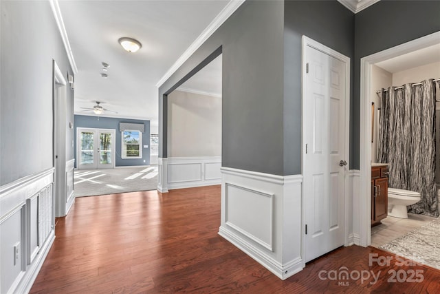 2439 Bergamot St, Fort Mill, SC 29708 - corridor with wood finished floors, ornamental molding, french doors, wainscoting, and a decorative wall