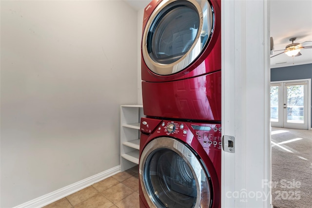 2439 Bergamot St, Fort Mill, SC 29708 - clothes washing area featuring a ceiling fan, baseboards, tile patterned flooring, french doors, and stacked washer and clothes dryer