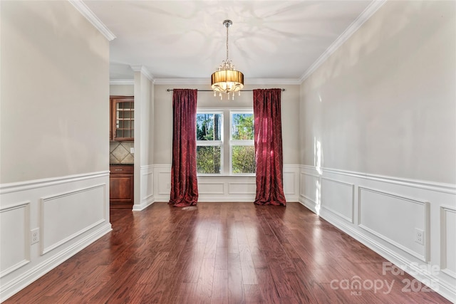 2439 Bergamot St, Fort Mill, SC 29708 - empty room with a notable chandelier, ornamental molding, and dark wood-style flooring